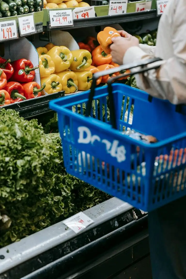 Persoon met boodschappenmandje in supermarkt